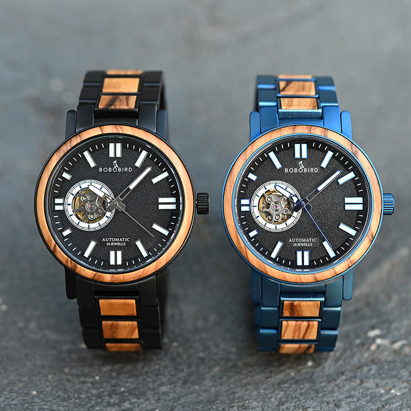 Comparison of two mechanical watch movements on a watchmaker's workbench